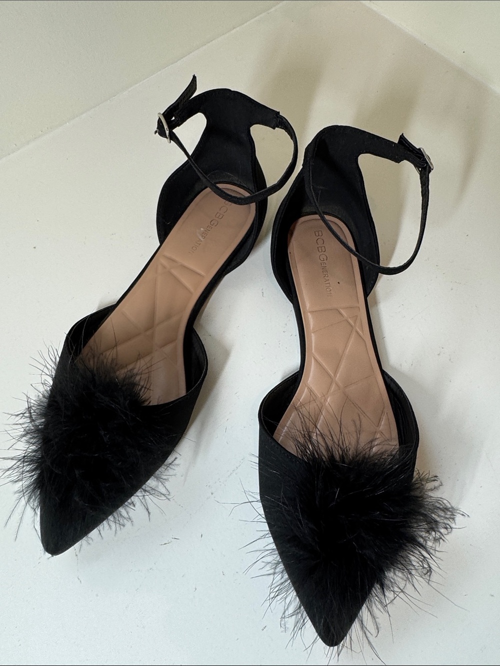BCBG generation back strap black flats with black feather detail. 10.